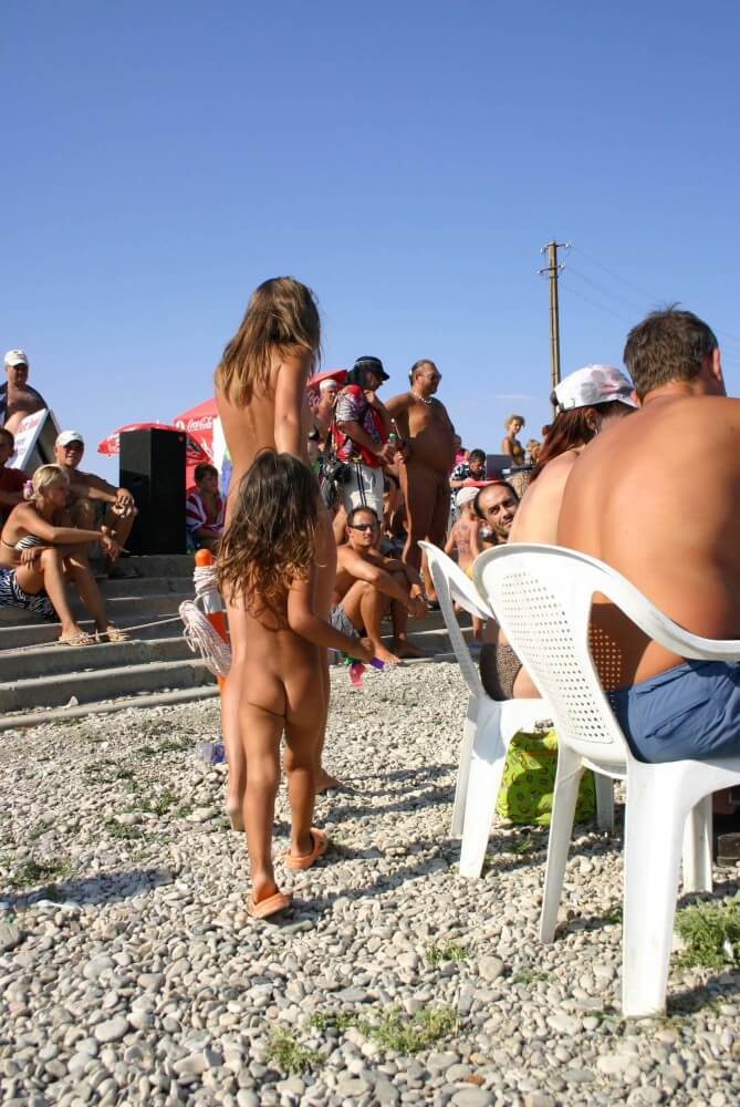 Naturist Standing Sideline - Beautiful family nudism