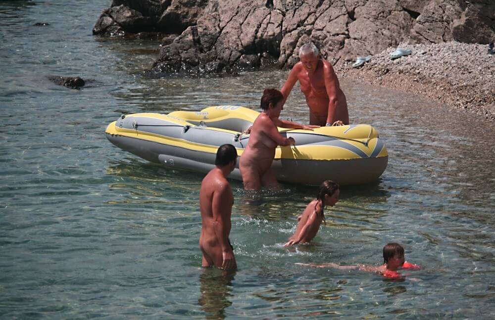 Lone Nudist in Yellow Boat photos - Nudism has an ancient history