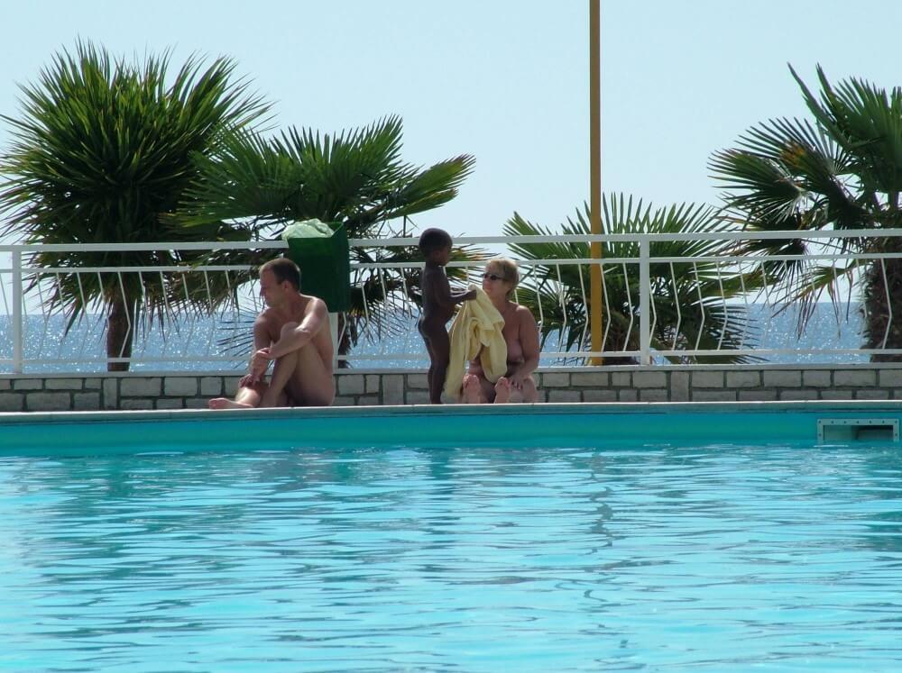 Photo of naturists in an outdoor pool - Nature is considered the bodys natural clothing
